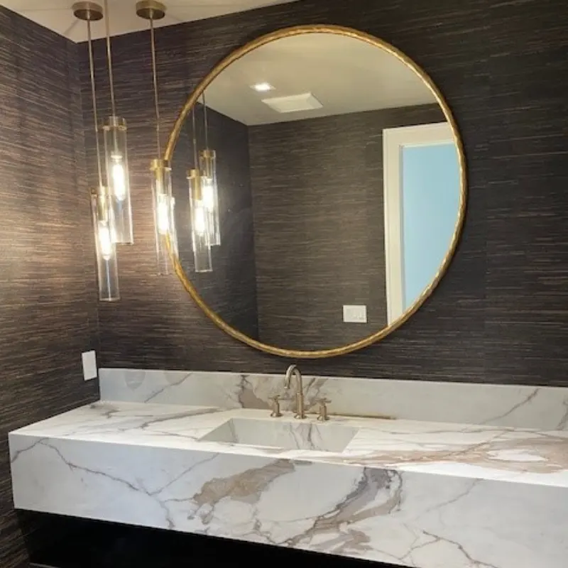 Luxury floating Calacatta Gold Quartz Vanity Top with seamless mitred apron edge and integrated sink.