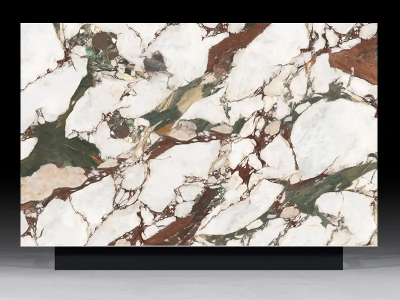 High-contrast Calacatta Viola Breccia quartz slab featuring oversized white blocks and dramatic burgundy green veining for luxury interiors.