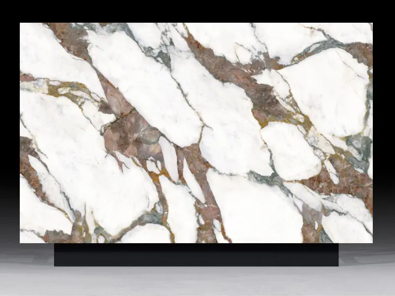 Polished Calacatta Viola quartz slab featuring bold burgundy and emerald green brecciated veining for luxury countertops.