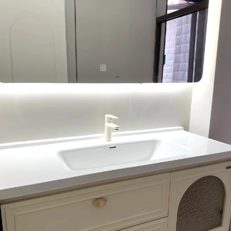 High-gloss white rectangular ceramic bathroom sink basin seamlessly integrated into a modern vanity by Miya Stone.