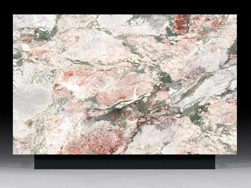 Multi-chromatic Four Seasons quartz slab featuring rose pink and forest green crystalline patterns for high-end architectural interiors.
