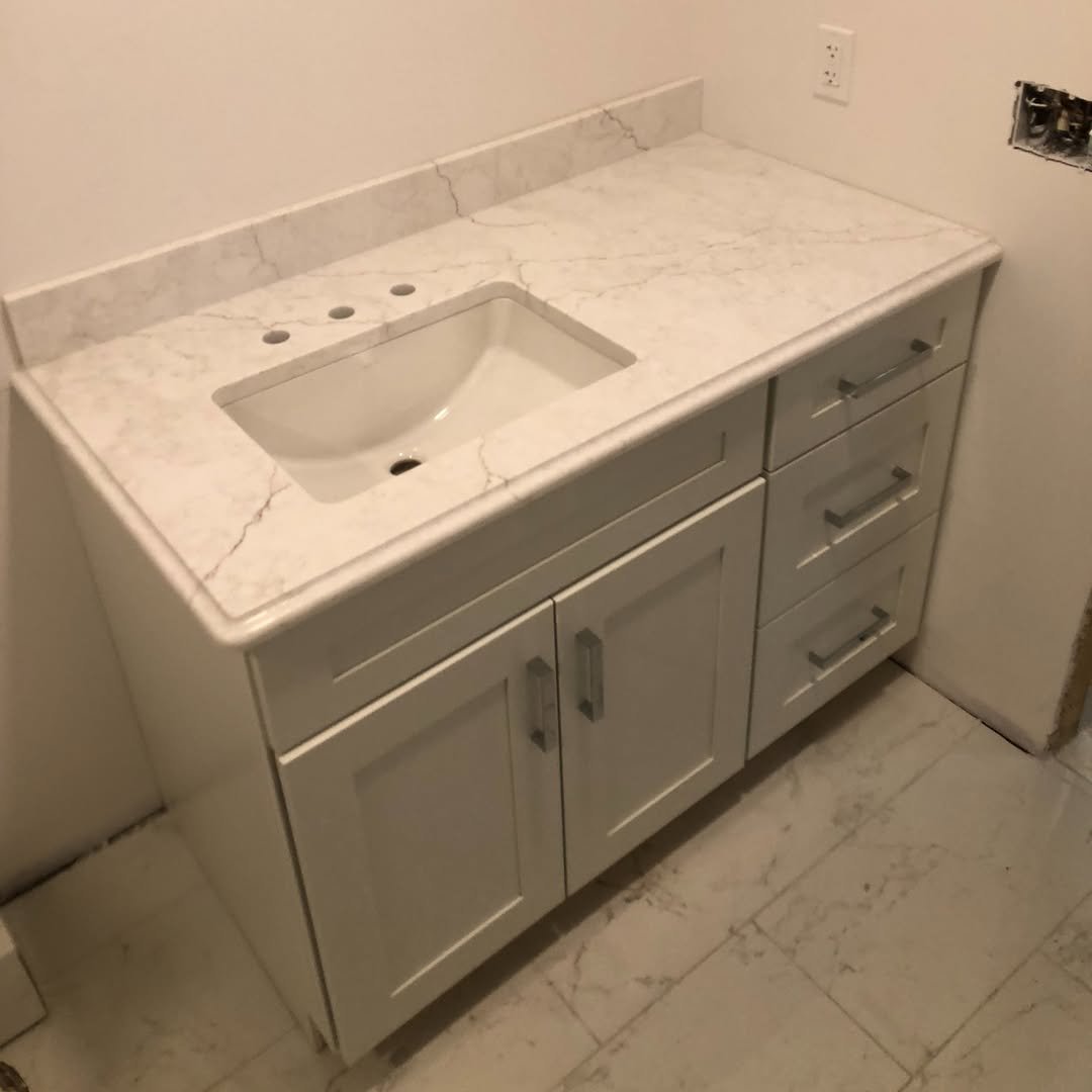 Integrated White Shaker Bathroom Vanity Top and Cabinet with Calacatta quartz surface for modern residential projects.