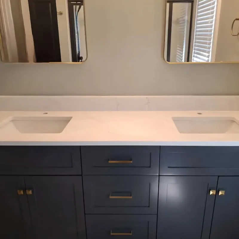 Symmetrical White Quartz Vanity Top with double sink configuration on dark Shaker cabinetry.